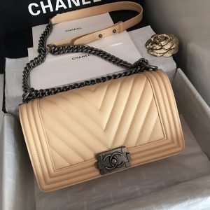 CHANEL Chevron Quilted Leather Flap Bag. Original high quality bag. Authentic design. Original quality printed dust bag and sales box. Created by Karl Lagerfeld, the iconic design owes its name to Gabrielle Chanel's first love, Boy Capel. This Chanel Boy Flap Bag Quilted is every woman's dream. Crafted from calfskin leather, the bag features Chanel's signature chevron quilting, chunky chain link strap with leather shoulder pad, and metal-tone hardware accents. Its CC Boy logo closure opens to a fabric-lined interior with slip pocket perfect for daily essentials. A sought-after, luxurious accessory.