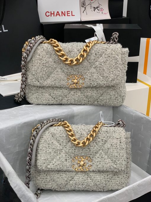 CHANEL 19 Flap Bag. Authentic quality luxury bag crafted in genuine leather comes with authenticity card, dust bag and gift bag. Effortlessly timeless, delightfully on-trend. For an everlasting touch of Parisian elegance, investing in a Chanel flap bag is the ultimate choice. However, if you're looking for a bag that seamlessly blends timeless appeal with current trends, then the Chanel 19 Flap Bag is the absolute pinnacle and arguably the most coveted bag in the world right now. Crafted with meticulous attention to detail using exquisite Tweed Fibres and adorned with the iconic two-toned Chanel 19 hardware in both Gold and Ruthenium, this icon is undeniably a striking fashion statement. The interwoven chain gracefully drapes over your shoulder or can be doubled up on your arm, exuding a sophisticated charm. Under the visionary craftsmanship of Karl Lagerfeld, Chanel stays true to its heritage by introducing classic quilted bags with a contemporary edge. Versatility is the name of the game as this exquisite piece effortlessly complements any ensemble you can imagine.