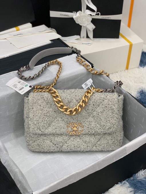 CHANEL 19 Flap Bag. Authentic quality luxury bag crafted in genuine leather comes with authenticity card, dust bag and gift bag. Effortlessly timeless, delightfully on-trend. For an everlasting touch of Parisian elegance, investing in a Chanel flap bag is the ultimate choice. However, if you're looking for a bag that seamlessly blends timeless appeal with current trends, then the Chanel 19 Flap Bag is the absolute pinnacle and arguably the most coveted bag in the world right now. Crafted with meticulous attention to detail using exquisite Tweed Fibres and adorned with the iconic two-toned Chanel 19 hardware in both Gold and Ruthenium, this icon is undeniably a striking fashion statement. The interwoven chain gracefully drapes over your shoulder or can be doubled up on your arm, exuding a sophisticated charm. Under the visionary craftsmanship of Karl Lagerfeld, Chanel stays true to its heritage by introducing classic quilted bags with a contemporary edge. Versatility is the name of the game as this exquisite piece effortlessly complements any ensemble you can imagine.