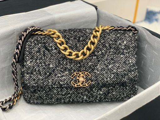 CHANEL 19 Flap Bag. Authentic quality luxury bag crafted in genuine leather comes with authenticity card, dust bag and gift bag. Effortlessly timeless, delightfully on-trend. For an everlasting touch of Parisian elegance, investing in a Chanel flap bag is the ultimate choice. However, if you're looking for a bag that seamlessly blends timeless appeal with current trends, then the Chanel 19 Flap Bag is the absolute pinnacle and arguably the most coveted bag in the world right now. Crafted with meticulous attention to detail using exquisite Tweed Fibres and adorned with the iconic two-toned Chanel 19 hardware in both Gold and Ruthenium, this icon is undeniably a striking fashion statement. The interwoven chain gracefully drapes over your shoulder or can be doubled up on your arm, exuding a sophisticated charm. Under the visionary craftsmanship of Karl Lagerfeld, Chanel stays true to its heritage by introducing classic quilted bags with a contemporary edge. Versatility is the name of the game as this exquisite piece effortlessly complements any ensemble you can imagine.