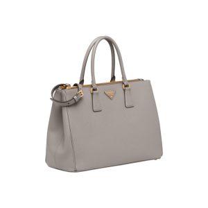 PRADA Galleria Saffiano Leather Bag. Authentic quality luxury bag crafted in genuine leather comes with authenticity card, dust bag and gift bag. An Icon of Timeless Elegance. The Prada Galleria bag embodies a timeless elegance that is truly unmatched. It takes its name from the iconic Prada store, which was first established by Mario Prada back in 1913 within the prestigious Galleria Vittorio Emanuele II of Milan. This exceptional design seamlessly blends tradition and modernity, captivating with its minimalist yet refined aesthetic. - KRIS + KIKO PRADA Galleria Saffiano Leather Bag. Original Quality Bag including gift box, literature, dust bag, authenticity card. The Prada Galleria bag, the quintessence of timeless elegance, is named after the historic Prada store that Mario Prada opened in 1913 in the Galleria Vittorio Emanuele II of Milan. Tradition and modernity meet in the design that is both minimalist and refined.