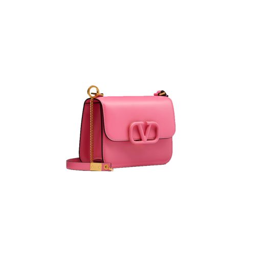VALENTINO VSling Mini Leather Shoulder Bag. Authentic quality luxury bag crafted in genuine leather comes with authenticity card, dust bag and gift bag. Elegance Meets Functionality. VALENTINO's SS20 accessories collection showcases their new V Ring logo, which has left us completely captivated. Pierpaolo Picciolil's attention to clean lines and thoughtful details is evident in this exquisite orange leather V-logo bag. The adjustable cross-body strap adds functionality to its elegance, while the iconic logo plaque graces the front flap. Inside, a black leather interior with a convenient slip pocket awaits. For a chic ensemble, pair it with a blouse tucked into a midi skirt and wear it gracefully over your shoulder.