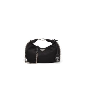PRADA Re-Edition 2006 Nylon Hobo. Authentic quality luxury bag crafted in genuine leather comes with authenticity card, dust bag and gift bag. Classic Silhouette, Modern Functionality, Unforgettable Style. Crafted from the renowned and recognizable nylon, a fabric emblematic of the brand, this shoulder bag effortlessly melds a timeless design with contemporary and practical elements. Enhancing its appeal are the detachable chain shoulder strap and the Re-Edition leather keyring, further elevating this accessory. - KRIS + KIKO PRADA Re-Edition 2006 Nylon Hobo. Authentic quality luxury bag crafted in genuine leather comes with authenticity card, dust bag and gift bag. Classic Silhouette, Modern Functionality, Unforgettable Style. Crafted from the renowned and recognizable nylon, a fabric emblematic of the brand, this shoulder bag effortlessly melds a timeless design with contemporary and practical elements. Enhancing its appeal are the detachable chain shoulder strap and the Re-Edition leather keyring, further elevating this accessory.