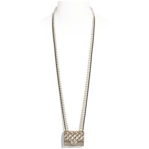 CHANEL Long Necklace. Authentic quality luxury bag crafted in genuine leather comes with authenticity card, dust bag and gift bag. Adorn yourself with timeless elegance. Introducing the exquisite CHANEL Long Necklace in a captivating combination of Gold, Black, and Pearly White, which proudly belongs to the esteemed Spring-Summer 2021 fashion collection. Meticulously designed and masterfully crafted, this stunning piece showcases the exceptional artistry and dedication synonymous with the iconic House of CHANEL.