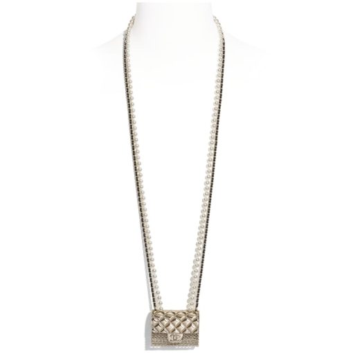 CHANEL Long Necklace. Authentic quality luxury bag crafted in genuine leather comes with authenticity card, dust bag and gift bag. Adorn yourself with timeless elegance. Introducing the exquisite CHANEL Long Necklace in a captivating combination of Gold, Black, and Pearly White, which proudly belongs to the esteemed Spring-Summer 2021 fashion collection. Meticulously designed and masterfully crafted, this stunning piece showcases the exceptional artistry and dedication synonymous with the iconic House of CHANEL.