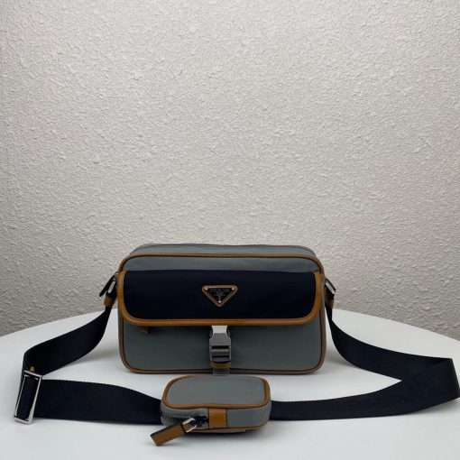PRADA Nylon Cross-Body Bag. Original Quality Bag including gift box, care book, dust bag, authenticity card. This bag decorated with Saffiano leather trim presents compact volumes and a sleek design. With its distinctive side release buckle on the front, it comes with an easily adjustable shoulder strap. This cross-body bag featuring Saffiano leather trim with metal hardware and Prada logo lining, logo tag inside, enameled metal triangle logo outside. It has a main compartment with zipper, secondary compartment with flap and side release buckle, two front pockets, including one with zipper.