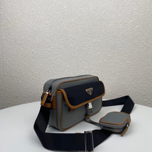 PRADA Nylon Cross-Body Bag. Authentic quality luxury bag crafted in genuine leather comes with authenticity card, dust bag and gift bag. Indulge in Effortless Elegance. This beautifully crafted bag, adorned with luxurious Saffiano leather trim, exudes elegance and sophistication. Its compact size and sleek design make it a perfect choice for any occasion. The distinctive side release buckle on the front adds a touch of uniqueness, while the adjustable shoulder strap ensures comfortable wear. The bag features impeccable details such as metal hardware, the iconic Prada logo lining, a logo tag inside, and an enameled metal triangle logo outside. It offers convenient storage with a spacious main compartment secured by a zipper, a secondary compartment with a flap and side release buckle, and two front pockets, including one with a zipper closure.