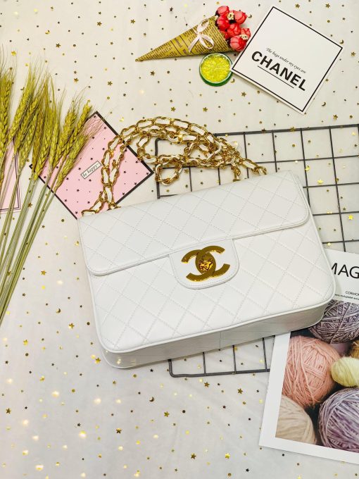 CHANEL Classic Flap Jumbo Bag. Authentic quality luxury bag crafted in genuine leather comes with authenticity card, dust bag and gift bag. Classic elegance with a modern twist. Introducing the Chanel Classic Mademoiselle Chain Lambskin Flap Bag, an essential item that embodies the essence of Chanel. This timeless piece features the iconic CC buckle and is beautifully enhanced with gold-plated Mademoiselle Chain straps. With this reinterpretation of the classic design, you can wear it as a clutch, effortlessly drape it over your shoulder, or enjoy the convenience of going hands-free with the option of wearing it cross-body.