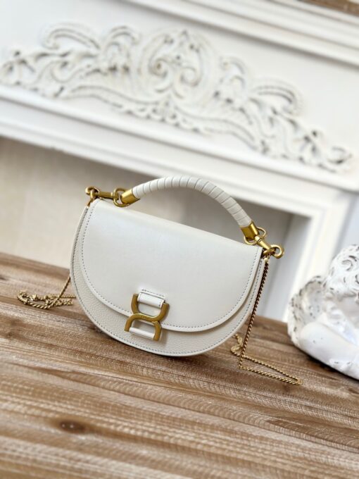 CHLOÉ Marcie Chain Flap Bag. Authentic quality luxury bag crafted in genuine leather comes with authenticity card, dust bag and gift bag. Elevating Iconic Elegance: Marcie Line Redefined. Experience a fresh take on Chloé's iconic Marcie line with this exquisite chain flap bag, meticulously crafted from a captivating blend of nappa lambskin, grained calfskin, and sumptuous suede. The line's signature hardware undergoes a graceful transformation, now adorned with Chloé's engraved jewelry hallmark, adorning the flap with sophistication. An intricately hand-braided top handle pays homage to another hallmark Marcie feature, while a gracefully extended chain strap adds a refined touch. Whether you choose to drape it over your shoulder or wear it cross-body during the day, or opt to detach the strap and carry it by hand for a sophisticated evening ensemble, this flap bag is a versatile masterpiece. Chloé's Marcie bag line effortlessly melds a feminine aesthetic with the free-spirited vibe of the '70s. An equestrian-inspired allure takes center stage, elevated by the allure of gleaming gold-toned hardware, resulting in a distinctly feminine yet timelessly chic look.