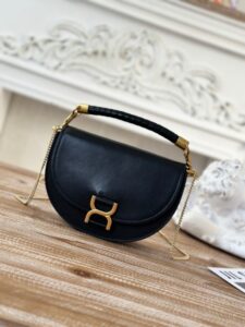 CHLOÉ Marcie Chain Flap Bag. Authentic quality luxury bag crafted in genuine leather comes with authenticity card, dust bag and gift bag. Elevating Iconic Elegance: Marcie Line Redefined. Experience a fresh take on Chloé's iconic Marcie line with this exquisite chain flap bag, meticulously crafted from a captivating blend of nappa lambskin, grained calfskin, and sumptuous suede. The line's signature hardware undergoes a graceful transformation, now adorned with Chloé's engraved jewelry hallmark, adorning the flap with sophistication. An intricately hand-braided top handle pays homage to another hallmark Marcie feature, while a gracefully extended chain strap adds a refined touch. Whether you choose to drape it over your shoulder or wear it cross-body during the day, or opt to detach the strap and carry it by hand for a sophisticated evening ensemble, this flap bag is a versatile masterpiece. Chloé's Marcie bag line effortlessly melds a feminine aesthetic with the free-spirited vibe of the '70s. An equestrian-inspired allure takes center stage, elevated by the allure of gleaming gold-toned hardware, resulting in a distinctly feminine yet timelessly chic look. - KRIS + KIKO CHLOÉ Marcie Chain Flap Bag. Authentic quality luxury bag crafted in genuine leather comes with authenticity card, dust bag and gift bag. Elevating Iconic Elegance: Marcie Line Redefined. Experience a fresh take on Chloé's iconic Marcie line with this exquisite chain flap bag, meticulously crafted from a captivating blend of nappa lambskin, grained calfskin, and sumptuous suede. The line's signature hardware undergoes a graceful transformation, now adorned with Chloé's engraved jewelry hallmark, adorning the flap with sophistication. An intricately hand-braided top handle pays homage to another hallmark Marcie feature, while a gracefully extended chain strap adds a refined touch. Whether you choose to drape it over your shoulder or wear it cross-body during the day, or opt to detach the strap and carry it by hand for a sophisticated evening ensemble, this flap bag is a versatile masterpiece. Chloé's Marcie bag line effortlessly melds a feminine aesthetic with the free-spirited vibe of the '70s. An equestrian-inspired allure takes center stage, elevated by the allure of gleaming gold-toned hardware, resulting in a distinctly feminine yet timelessly chic look.