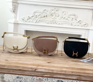 CHLOÉ Marcie Chain Flap Bag. Authentic quality luxury bag crafted in genuine leather comes with authenticity card, dust bag and gift bag. Elevating Iconic Elegance: Marcie Line Redefined. Experience a fresh take on Chloé's iconic Marcie line with this exquisite chain flap bag, meticulously crafted from a captivating blend of nappa lambskin, grained calfskin, and sumptuous suede. The line's signature hardware undergoes a graceful transformation, now adorned with Chloé's engraved jewelry hallmark, adorning the flap with sophistication. An intricately hand-braided top handle pays homage to another hallmark Marcie feature, while a gracefully extended chain strap adds a refined touch. Whether you choose to drape it over your shoulder or wear it cross-body during the day, or opt to detach the strap and carry it by hand for a sophisticated evening ensemble, this flap bag is a versatile masterpiece. Chloé's Marcie bag line effortlessly melds a feminine aesthetic with the free-spirited vibe of the '70s. An equestrian-inspired allure takes center stage, elevated by the allure of gleaming gold-toned hardware, resulting in a distinctly feminine yet timelessly chic look. - KRIS + KIKO CHLOÉ Marcie Chain Flap Bag. Authentic quality luxury bag crafted in genuine leather comes with authenticity card, dust bag and gift bag. Elevating Iconic Elegance: Marcie Line Redefined. Experience a fresh take on Chloé's iconic Marcie line with this exquisite chain flap bag, meticulously crafted from a captivating blend of nappa lambskin, grained calfskin, and sumptuous suede. The line's signature hardware undergoes a graceful transformation, now adorned with Chloé's engraved jewelry hallmark, adorning the flap with sophistication. An intricately hand-braided top handle pays homage to another hallmark Marcie feature, while a gracefully extended chain strap adds a refined touch. Whether you choose to drape it over your shoulder or wear it cross-body during the day, or opt to detach the strap and carry it by hand for a sophisticated evening ensemble, this flap bag is a versatile masterpiece. Chloé's Marcie bag line effortlessly melds a feminine aesthetic with the free-spirited vibe of the '70s. An equestrian-inspired allure takes center stage, elevated by the allure of gleaming gold-toned hardware, resulting in a distinctly feminine yet timelessly chic look.