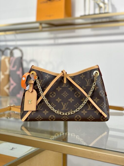 LOUIS VUITTON CarryAll BB. Authentic quality luxury bag crafted in genuine leather comes with authenticity card, dust bag and gift bag. Effortless Elegance, Day to Night – The CarryAll BB Reimagined. The iconic CarryAll BB returns this season with a stylish twist, perfect for transitioning from day to evening. Expertly crafted from the House’s signature Monogram canvas, it’s elevated with a gleaming gold-toned chain adorned with Monogram Flowers. Thoughtful details like the contrasting leather name tag and matching lace closure add a refined touch. Inside, a zipped pocket offers a convenient spot to keep your everyday essentials—like a credit card—close at hand.