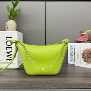 LOEWE Mini Hammock Hobo. Authentic quality luxury bag crafted in genuine leather comes with authenticity card, dust bag and gift bag. Effortless Form, Everyday Function. The Mini Hammock Hobo is a contemporary reimagining of Loewe’s iconic Hammock bag. This streamlined variation offers a sleek, sculptural silhouette designed as a versatile sling bag for modern living. Expertly crafted in classic calfskin, it features soft, supple leather and a compact form that adapts effortlessly to your day. The unique design allows for multiple carry options—wear it crossbody, over the shoulder, or by hand. Elegant yet functional, this mini hobo is perfect for essentials, making it an ideal choice for both daily wear and minimalist style statements.