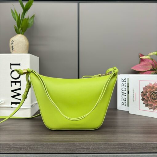 LOEWE Mini Hammock Hobo. Authentic quality luxury bag crafted in genuine leather comes with authenticity card, dust bag and gift bag. Effortless Form, Everyday Function. The Mini Hammock Hobo is a contemporary reimagining of Loewe’s iconic Hammock bag. This streamlined variation offers a sleek, sculptural silhouette designed as a versatile sling bag for modern living. Expertly crafted in classic calfskin, it features soft, supple leather and a compact form that adapts effortlessly to your day. The unique design allows for multiple carry options—wear it crossbody, over the shoulder, or by hand. Elegant yet functional, this mini hobo is perfect for essentials, making it an ideal choice for both daily wear and minimalist style statements.