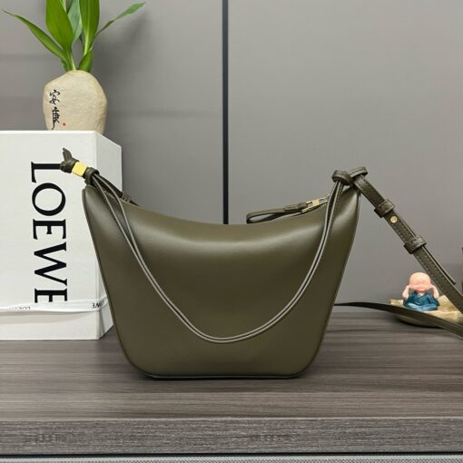 LOEWE Mini Hammock Hobo. Authentic quality luxury bag crafted in genuine leather comes with authenticity card, dust bag and gift bag. Effortless Form, Everyday Function. The Mini Hammock Hobo is a contemporary reimagining of Loewe’s iconic Hammock bag. This streamlined variation offers a sleek, sculptural silhouette designed as a versatile sling bag for modern living. Expertly crafted in classic calfskin, it features soft, supple leather and a compact form that adapts effortlessly to your day. The unique design allows for multiple carry options—wear it crossbody, over the shoulder, or by hand. Elegant yet functional, this mini hobo is perfect for essentials, making it an ideal choice for both daily wear and minimalist style statements.