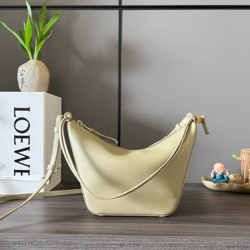 LOEWE Mini Hammock Hobo. Authentic quality luxury bag crafted in genuine leather comes with authenticity card, dust bag and gift bag. Effortless Form, Everyday Function. The Mini Hammock Hobo is a contemporary reimagining of Loewe’s iconic Hammock bag. This streamlined variation offers a sleek, sculptural silhouette designed as a versatile sling bag for modern living. Expertly crafted in classic calfskin, it features soft, supple leather and a compact form that adapts effortlessly to your day. The unique design allows for multiple carry options—wear it crossbody, over the shoulder, or by hand. Elegant yet functional, this mini hobo is perfect for essentials, making it an ideal choice for both daily wear and minimalist style statements.