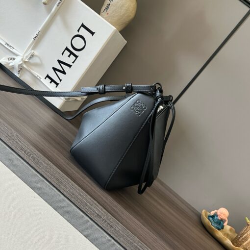 LOEWE Mini Hammock Hobo. Authentic quality luxury bag crafted in genuine leather comes with authenticity card, dust bag and gift bag. Effortless Form, Everyday Function. The Mini Hammock Hobo is a contemporary reimagining of Loewe’s iconic Hammock bag. This streamlined variation offers a sleek, sculptural silhouette designed as a versatile sling bag for modern living. Expertly crafted in classic calfskin, it features soft, supple leather and a compact form that adapts effortlessly to your day. The unique design allows for multiple carry options—wear it crossbody, over the shoulder, or by hand. Elegant yet functional, this mini hobo is perfect for essentials, making it an ideal choice for both daily wear and minimalist style statements.