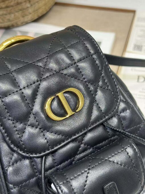 DIOR Small Caro Backpack. Authentic quality luxury bag crafted in genuine leather comes with authenticity card, dust bag and gift bag. Elegance Meets Effortless Edge. Elevate your everyday with the DIOR Small Caro Backpack — a flawless blend of modern femininity and iconic House craftsmanship. Luxuriously crafted in lambskin, its supple silhouette is enhanced by bold Macrocannage topstitching that whispers timeless Dior style. The antique gold-finish ‘CD’ clasp opens to a drawstring main compartment, perfectly balancing beauty and practicality. A discreet flap pocket keeps your daily essentials close at hand, while the top handle and adjustable leather straps offer versatile, all-day comfort. Whether slung over your shoulder or carried by hand, this petite powerhouse delivers Parisian polish in every step.