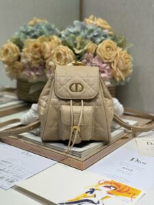 0DIOR Small Caro Backpack. Authentic quality luxury bag crafted in genuine leather comes with authenticity card, dust bag and gift bag. Elegance Meets Effortless Edge. Elevate your everyday with the DIOR Small Caro Backpack — a flawless blend of modern femininity and iconic House craftsmanship. Luxuriously crafted in lambskin, its supple silhouette is enhanced by bold Macrocannage topstitching that whispers timeless Dior style. The antique gold-finish ‘CD’ clasp opens to a drawstring main compartment, perfectly balancing beauty and practicality. A discreet flap pocket keeps your daily essentials close at hand, while the top handle and adjustable leather straps offer versatile, all-day comfort. Whether slung over your shoulder or carried by hand, this petite powerhouse delivers Parisian polish in every step. - KRIS + KIKO DIOR Small Caro Backpack. Authentic quality luxury bag crafted in genuine leather comes with authenticity card, dust bag and gift bag. Elegance Meets Effortless Edge. Elevate your everyday with the DIOR Small Caro Backpack — a flawless blend of modern femininity and iconic House craftsmanship. Luxuriously crafted in lambskin, its supple silhouette is enhanced by bold Macrocannage topstitching that whispers timeless Dior style. The antique gold-finish ‘CD’ clasp opens to a drawstring main compartment, perfectly balancing beauty and practicality. A discreet flap pocket keeps your daily essentials close at hand, while the top handle and adjustable leather straps offer versatile, all-day comfort. Whether slung over your shoulder or carried by hand, this petite powerhouse delivers Parisian polish in every step.