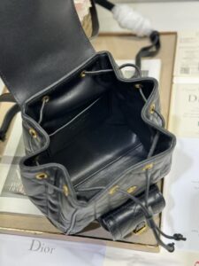 DIOR Small Caro Backpack. Authentic quality luxury bag crafted in genuine leather comes with authenticity card, dust bag and gift bag. Elegance Meets Effortless Edge. Elevate your everyday with the DIOR Small Caro Backpack — a flawless blend of modern femininity and iconic House craftsmanship. Luxuriously crafted in lambskin, its supple silhouette is enhanced by bold Macrocannage topstitching that whispers timeless Dior style. The antique gold-finish ‘CD’ clasp opens to a drawstring main compartment, perfectly balancing beauty and practicality. A discreet flap pocket keeps your daily essentials close at hand, while the top handle and adjustable leather straps offer versatile, all-day comfort. Whether slung over your shoulder or carried by hand, this petite powerhouse delivers Parisian polish in every step. - KRIS + KIKO DIOR Small Caro Backpack. Authentic quality luxury bag crafted in genuine leather comes with authenticity card, dust bag and gift bag. Elegance Meets Effortless Edge. Elevate your everyday with the DIOR Small Caro Backpack — a flawless blend of modern femininity and iconic House craftsmanship. Luxuriously crafted in lambskin, its supple silhouette is enhanced by bold Macrocannage topstitching that whispers timeless Dior style. The antique gold-finish ‘CD’ clasp opens to a drawstring main compartment, perfectly balancing beauty and practicality. A discreet flap pocket keeps your daily essentials close at hand, while the top handle and adjustable leather straps offer versatile, all-day comfort. Whether slung over your shoulder or carried by hand, this petite powerhouse delivers Parisian polish in every step.