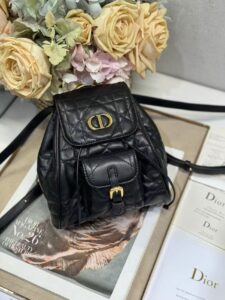 DIOR Small Caro Backpack. Authentic quality luxury bag crafted in genuine leather comes with authenticity card, dust bag and gift bag. Elegance Meets Effortless Edge. Elevate your everyday with the DIOR Small Caro Backpack — a flawless blend of modern femininity and iconic House craftsmanship. Luxuriously crafted in lambskin, its supple silhouette is enhanced by bold Macrocannage topstitching that whispers timeless Dior style. The antique gold-finish ‘CD’ clasp opens to a drawstring main compartment, perfectly balancing beauty and practicality. A discreet flap pocket keeps your daily essentials close at hand, while the top handle and adjustable leather straps offer versatile, all-day comfort. Whether slung over your shoulder or carried by hand, this petite powerhouse delivers Parisian polish in every step. - KRIS + KIKO DIOR Small Caro Backpack. Authentic quality luxury bag crafted in genuine leather comes with authenticity card, dust bag and gift bag. Elegance Meets Effortless Edge. Elevate your everyday with the DIOR Small Caro Backpack — a flawless blend of modern femininity and iconic House craftsmanship. Luxuriously crafted in lambskin, its supple silhouette is enhanced by bold Macrocannage topstitching that whispers timeless Dior style. The antique gold-finish ‘CD’ clasp opens to a drawstring main compartment, perfectly balancing beauty and practicality. A discreet flap pocket keeps your daily essentials close at hand, while the top handle and adjustable leather straps offer versatile, all-day comfort. Whether slung over your shoulder or carried by hand, this petite powerhouse delivers Parisian polish in every step.