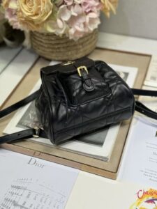 DIOR Small Caro Backpack. Authentic quality luxury bag crafted in genuine leather comes with authenticity card, dust bag and gift bag. Elegance Meets Effortless Edge. Elevate your everyday with the DIOR Small Caro Backpack — a flawless blend of modern femininity and iconic House craftsmanship. Luxuriously crafted in lambskin, its supple silhouette is enhanced by bold Macrocannage topstitching that whispers timeless Dior style. The antique gold-finish ‘CD’ clasp opens to a drawstring main compartment, perfectly balancing beauty and practicality. A discreet flap pocket keeps your daily essentials close at hand, while the top handle and adjustable leather straps offer versatile, all-day comfort. Whether slung over your shoulder or carried by hand, this petite powerhouse delivers Parisian polish in every step. - KRIS + KIKO DIOR Small Caro Backpack. Authentic quality luxury bag crafted in genuine leather comes with authenticity card, dust bag and gift bag. Elegance Meets Effortless Edge. Elevate your everyday with the DIOR Small Caro Backpack — a flawless blend of modern femininity and iconic House craftsmanship. Luxuriously crafted in lambskin, its supple silhouette is enhanced by bold Macrocannage topstitching that whispers timeless Dior style. The antique gold-finish ‘CD’ clasp opens to a drawstring main compartment, perfectly balancing beauty and practicality. A discreet flap pocket keeps your daily essentials close at hand, while the top handle and adjustable leather straps offer versatile, all-day comfort. Whether slung over your shoulder or carried by hand, this petite powerhouse delivers Parisian polish in every step.