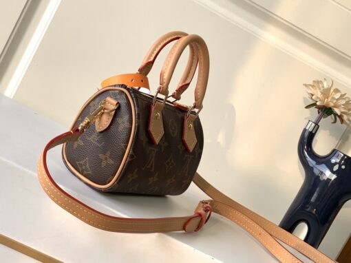 LOUIS VUITTON Speedy Nano. Authentic quality luxury bag crafted in genuine leather comes with authenticity card, dust bag and gift bag. Iconic Style, Perfectly Miniaturized. Meet the LOUIS VUITTON Speedy Nano— a petite powerhouse that captures the timeless allure of the iconic Speedy in its most charming form. Revamped in classic Monogram canvas and finished with aged natural cowhide leather, this mini marvel is made for the modern minimalist. Crafted with delicate gold-tone hardware and featuring two signature top handles, the Speedy Nano is both playful and practical. Its removable, adjustable shoulder strap adds effortless versatility—carry it by hand for polished poise or sling it crossbody for chic, on-the-go ease. Compact enough for your essentials. Iconic enough to turn heads. Small bag, big legacy!