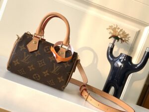 LOUIS VUITTON Speedy Nano. Authentic quality luxury bag crafted in genuine leather comes with authenticity card, dust bag and gift bag. Iconic Style, Perfectly Miniaturized. Meet the LOUIS VUITTON Speedy Nano— a petite powerhouse that captures the timeless allure of the iconic Speedy in its most charming form. Revamped in classic Monogram canvas and finished with aged natural cowhide leather, this mini marvel is made for the modern minimalist. Crafted with delicate gold-tone hardware and featuring two signature top handles, the Speedy Nano is both playful and practical. Its removable, adjustable shoulder strap adds effortless versatility—carry it by hand for polished poise or sling it crossbody for chic, on-the-go ease. Compact enough for your essentials. Iconic enough to turn heads. Small bag, big legacy! - KRIS + KIKO LOUIS VUITTON Speedy Nano. Authentic quality luxury bag crafted in genuine leather comes with authenticity card, dust bag and gift bag. Iconic Style, Perfectly Miniaturized. Meet the LOUIS VUITTON Speedy Nano— a petite powerhouse that captures the timeless allure of the iconic Speedy in its most charming form. Revamped in classic Monogram canvas and finished with aged natural cowhide leather, this mini marvel is made for the modern minimalist. Crafted with delicate gold-tone hardware and featuring two signature top handles, the Speedy Nano is both playful and practical. Its removable, adjustable shoulder strap adds effortless versatility—carry it by hand for polished poise or sling it crossbody for chic, on-the-go ease. Compact enough for your essentials. Iconic enough to turn heads. Small bag, big legacy!