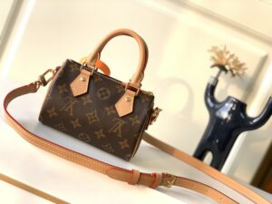 LOUIS VUITTON Speedy Nano. Authentic quality luxury bag crafted in genuine leather comes with authenticity card, dust bag and gift bag. Iconic Style, Perfectly Miniaturized. Meet the LOUIS VUITTON Speedy Nano— a petite powerhouse that captures the timeless allure of the iconic Speedy in its most charming form. Revamped in classic Monogram canvas and finished with aged natural cowhide leather, this mini marvel is made for the modern minimalist. Crafted with delicate gold-tone hardware and featuring two signature top handles, the Speedy Nano is both playful and practical. Its removable, adjustable shoulder strap adds effortless versatility—carry it by hand for polished poise or sling it crossbody for chic, on-the-go ease. Compact enough for your essentials. Iconic enough to turn heads. Small bag, big legacy! - KRIS + KIKO LOUIS VUITTON Speedy Nano. Authentic quality luxury bag crafted in genuine leather comes with authenticity card, dust bag and gift bag. Iconic Style, Perfectly Miniaturized. Meet the LOUIS VUITTON Speedy Nano— a petite powerhouse that captures the timeless allure of the iconic Speedy in its most charming form. Revamped in classic Monogram canvas and finished with aged natural cowhide leather, this mini marvel is made for the modern minimalist. Crafted with delicate gold-tone hardware and featuring two signature top handles, the Speedy Nano is both playful and practical. Its removable, adjustable shoulder strap adds effortless versatility—carry it by hand for polished poise or sling it crossbody for chic, on-the-go ease. Compact enough for your essentials. Iconic enough to turn heads. Small bag, big legacy!