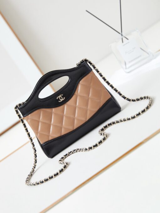 CHANEL 31 Nano Shopping Bag. Authentic quality luxury bag crafted in genuine leather comes with authenticity card, dust bag and gift bag. Small in size, grand in statement. A miniature marvel that captures the sophistication of CHANEL in its most playful form. Crafted with meticulous precision, this petite icon merges the timeless spirit of the CHANEL 31 with a modern twist on everyday elegance. Designed in supple lambskin and finished with gleaming gold-tone hardware, the Nano 31 doesn’t just carry your essentials — it carries your attitude. Whether worn crossbody, by hand, or dangling from the crook of your arm, this charming piece elevates every ensemble with a whisper of Parisian chic. Perfect for a night out or a day in the spotlight, it’s not just a bag — it’s your boldest accessory in its most compact form. Because luxury doesn't need to shout. Sometimes, it just needs to charm.