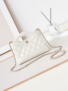 CHANEL 31 Nano Shopping Bag. Authentic quality luxury bag crafted in genuine leather comes with authenticity card, dust bag and gift bag. Small in size, grand in statement. A miniature marvel that captures the sophistication of CHANEL in its most playful form. Crafted with meticulous precision, this petite icon merges the timeless spirit of the CHANEL 31 with a modern twist on everyday elegance. Designed in supple lambskin and finished with gleaming gold-tone hardware, the Nano 31 doesn’t just carry your essentials — it carries your attitude. Whether worn crossbody, by hand, or dangling from the crook of your arm, this charming piece elevates every ensemble with a whisper of Parisian chic. Perfect for a night out or a day in the spotlight, it’s not just a bag — it’s your boldest accessory in its most compact form. Because luxury doesn't need to shout. Sometimes, it just needs to charm. - KRIS + KIKO CHANEL 31 Nano Shopping Bag. Authentic quality luxury bag crafted in genuine leather comes with authenticity card, dust bag and gift bag. Small in size, grand in statement. A miniature marvel that captures the sophistication of CHANEL in its most playful form. Crafted with meticulous precision, this petite icon merges the timeless spirit of the CHANEL 31 with a modern twist on everyday elegance. Designed in supple lambskin and finished with gleaming gold-tone hardware, the Nano 31 doesn’t just carry your essentials — it carries your attitude. Whether worn crossbody, by hand, or dangling from the crook of your arm, this charming piece elevates every ensemble with a whisper of Parisian chic. Perfect for a night out or a day in the spotlight, it’s not just a bag — it’s your boldest accessory in its most compact form. Because luxury doesn't need to shout. Sometimes, it just needs to charm.