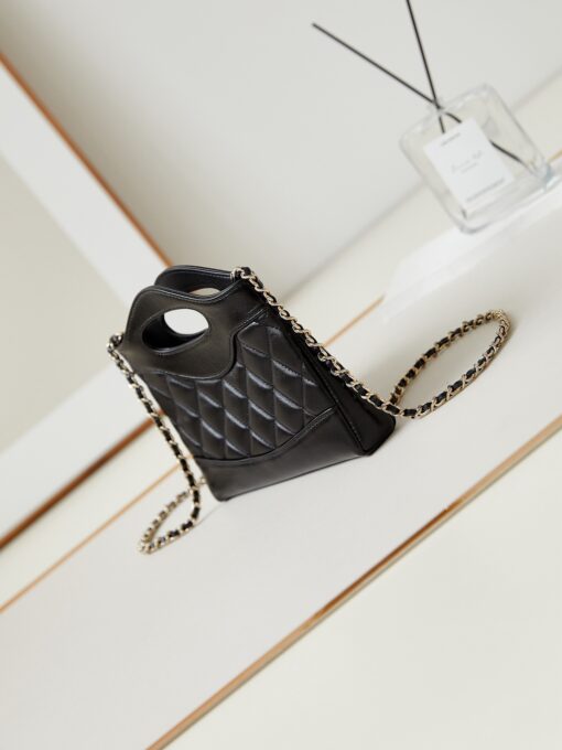 CHANEL 31 Nano Shopping Bag. Authentic quality luxury bag crafted in genuine leather comes with authenticity card, dust bag and gift bag. Small in size, grand in statement. A miniature marvel that captures the sophistication of CHANEL in its most playful form. Crafted with meticulous precision, this petite icon merges the timeless spirit of the CHANEL 31 with a modern twist on everyday elegance. Designed in supple lambskin and finished with gleaming gold-tone hardware, the Nano 31 doesn’t just carry your essentials — it carries your attitude. Whether worn crossbody, by hand, or dangling from the crook of your arm, this charming piece elevates every ensemble with a whisper of Parisian chic. Perfect for a night out or a day in the spotlight, it’s not just a bag — it’s your boldest accessory in its most compact form. Because luxury doesn't need to shout. Sometimes, it just needs to charm.