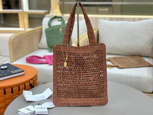 CHLOÉ Summer Banana Tote Bag. Authentic quality luxury bag crafted in genuine leather comes with authenticity card, dust bag and gift bag. Heritage in Hand: Where Artisan Craft Meets Summer Elegance. Introducing the Summer Banana Tote—an artisanal masterpiece crafted from raffia and calfskin by a single artisan over 4.5 days in partnership with Made For A Woman. This spacious tote is adorned with a handwritten signature inspired by Chloé’s rich heritage, while a playful dangling chain and delicate charms add the perfect finishing touch. A celebration of craftsmanship and effortless summer style.