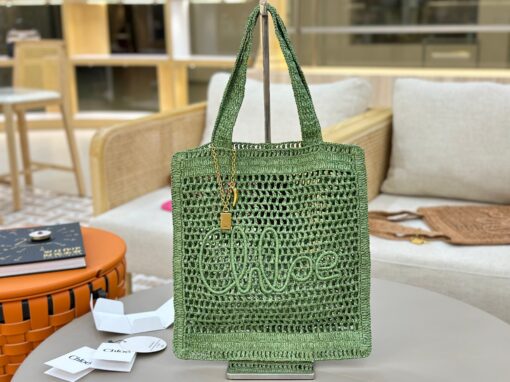 CHLOÉ Summer Banana Tote Bag. Authentic quality luxury bag crafted in genuine leather comes with authenticity card, dust bag and gift bag. Heritage in Hand: Where Artisan Craft Meets Summer Elegance. Introducing the Summer Banana Tote—an artisanal masterpiece crafted from raffia and calfskin by a single artisan over 4.5 days in partnership with Made For A Woman. This spacious tote is adorned with a handwritten signature inspired by Chloé’s rich heritage, while a playful dangling chain and delicate charms add the perfect finishing touch. A celebration of craftsmanship and effortless summer style.