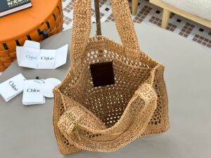 CHLOÉ Summer Banana Tote Bag. Authentic quality luxury bag crafted in genuine leather comes with authenticity card, dust bag and gift bag. Heritage in Hand: Where Artisan Craft Meets Summer Elegance. Introducing the Summer Banana Tote—an artisanal masterpiece crafted from raffia and calfskin by a single artisan over 4.5 days in partnership with Made For A Woman. This spacious tote is adorned with a handwritten signature inspired by Chloé’s rich heritage, while a playful dangling chain and delicate charms add the perfect finishing touch. A celebration of craftsmanship and effortless summer style. - KRIS + KIKO CHLOÉ Summer Banana Tote Bag. Authentic quality luxury bag crafted in genuine leather comes with authenticity card, dust bag and gift bag. Heritage in Hand: Where Artisan Craft Meets Summer Elegance. Introducing the Summer Banana Tote—an artisanal masterpiece crafted from raffia and calfskin by a single artisan over 4.5 days in partnership with Made For A Woman. This spacious tote is adorned with a handwritten signature inspired by Chloé’s rich heritage, while a playful dangling chain and delicate charms add the perfect finishing touch. A celebration of craftsmanship and effortless summer style.