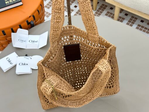 CHLOÉ Summer Banana Tote Bag. Authentic quality luxury bag crafted in genuine leather comes with authenticity card, dust bag and gift bag. Heritage in Hand: Where Artisan Craft Meets Summer Elegance. Introducing the Summer Banana Tote—an artisanal masterpiece crafted from raffia and calfskin by a single artisan over 4.5 days in partnership with Made For A Woman. This spacious tote is adorned with a handwritten signature inspired by Chloé’s rich heritage, while a playful dangling chain and delicate charms add the perfect finishing touch. A celebration of craftsmanship and effortless summer style.