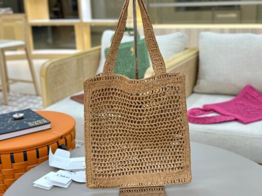 CHLOÉ Summer Banana Tote Bag. Authentic quality luxury bag crafted in genuine leather comes with authenticity card, dust bag and gift bag. Heritage in Hand: Where Artisan Craft Meets Summer Elegance. Introducing the Summer Banana Tote—an artisanal masterpiece crafted from raffia and calfskin by a single artisan over 4.5 days in partnership with Made For A Woman. This spacious tote is adorned with a handwritten signature inspired by Chloé’s rich heritage, while a playful dangling chain and delicate charms add the perfect finishing touch. A celebration of craftsmanship and effortless summer style.