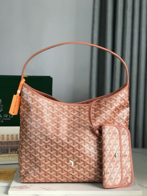 GOYARD Bohème Hobo Bag. Authentic quality luxury bag crafted in genuine leather comes with authenticity card, dust bag and gift bag. Wander Freely. Carry Elegantly. Introducing the Goyard Bohème Hobo Bag—a tribute to Parisian spirit and wanderlust. Inspired by the timber raftsmen’s humble travel pouches, this bag blends heritage storytelling with everyday luxury. Crafted to be exceptionally lightweight and flexible, it drapes effortlessly on your shoulder with a wide, comfortable handle designed for long city strolls or spontaneous weekend escapes. Its beauty lies not only in its sleek silhouette but also in its thoughtful functionality. The secure zip closure keeps your essentials safe, while the removable snap-fastened pouch doubles as a chic clutch or wallet—perfect for a quick dash or stylish switch-up. Whether you’re wandering through cobblestone streets or navigating your daily routine, the Bohème ensures your essentials are always within reach. This is not just a bag—it’s your elegant partner in carefree adventures.