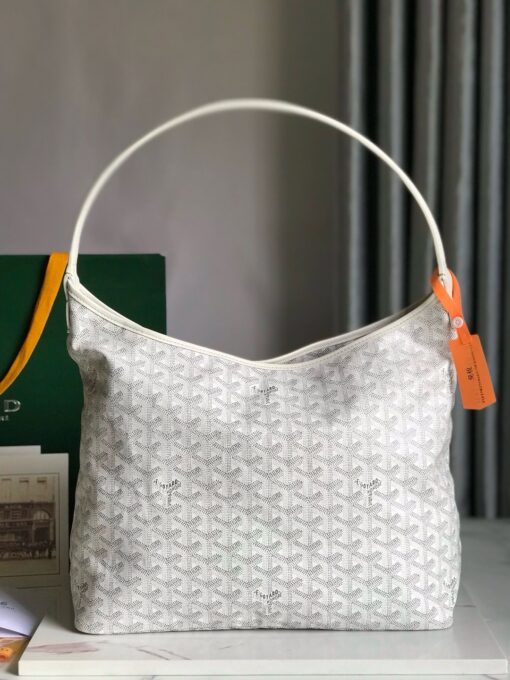 GOYARD Bohème Hobo Bag. Authentic quality luxury bag crafted in genuine leather comes with authenticity card, dust bag and gift bag. Wander Freely. Carry Elegantly. Introducing the Goyard Bohème Hobo Bag—a tribute to Parisian spirit and wanderlust. Inspired by the timber raftsmen’s humble travel pouches, this bag blends heritage storytelling with everyday luxury. Crafted to be exceptionally lightweight and flexible, it drapes effortlessly on your shoulder with a wide, comfortable handle designed for long city strolls or spontaneous weekend escapes. Its beauty lies not only in its sleek silhouette but also in its thoughtful functionality. The secure zip closure keeps your essentials safe, while the removable snap-fastened pouch doubles as a chic clutch or wallet—perfect for a quick dash or stylish switch-up. Whether you’re wandering through cobblestone streets or navigating your daily routine, the Bohème ensures your essentials are always within reach. This is not just a bag—it’s your elegant partner in carefree adventures.