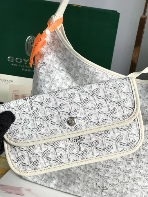 GOYARD Bohème Hobo Bag. Authentic quality luxury bag crafted in genuine leather comes with authenticity card, dust bag and gift bag. Wander Freely. Carry Elegantly. Introducing the Goyard Bohème Hobo Bag—a tribute to Parisian spirit and wanderlust. Inspired by the timber raftsmen’s humble travel pouches, this bag blends heritage storytelling with everyday luxury. Crafted to be exceptionally lightweight and flexible, it drapes effortlessly on your shoulder with a wide, comfortable handle designed for long city strolls or spontaneous weekend escapes. Its beauty lies not only in its sleek silhouette but also in its thoughtful functionality. The secure zip closure keeps your essentials safe, while the removable snap-fastened pouch doubles as a chic clutch or wallet—perfect for a quick dash or stylish switch-up. Whether you’re wandering through cobblestone streets or navigating your daily routine, the Bohème ensures your essentials are always within reach. This is not just a bag—it’s your elegant partner in carefree adventures.