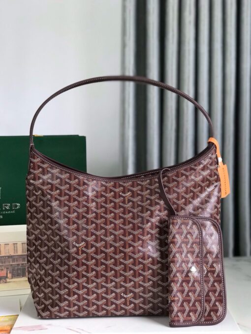 GOYARD Bohème Hobo Bag. Authentic quality luxury bag crafted in genuine leather comes with authenticity card, dust bag and gift bag. Wander Freely. Carry Elegantly. Introducing the Goyard Bohème Hobo Bag—a tribute to Parisian spirit and wanderlust. Inspired by the timber raftsmen’s humble travel pouches, this bag blends heritage storytelling with everyday luxury. Crafted to be exceptionally lightweight and flexible, it drapes effortlessly on your shoulder with a wide, comfortable handle designed for long city strolls or spontaneous weekend escapes. Its beauty lies not only in its sleek silhouette but also in its thoughtful functionality. The secure zip closure keeps your essentials safe, while the removable snap-fastened pouch doubles as a chic clutch or wallet—perfect for a quick dash or stylish switch-up. Whether you’re wandering through cobblestone streets or navigating your daily routine, the Bohème ensures your essentials are always within reach. This is not just a bag—it’s your elegant partner in carefree adventures.