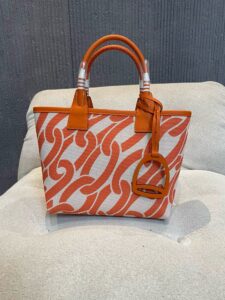 HERMÈS Steeple 25 Bag. Authentic quality luxury bag crafted in genuine leather comes with authenticity card, dust bag and gift bag. Where art meets heritage. The Hermès Steeple Bag is a charming fusion of heritage and artistry, crafted from a blend of canvas and Swift leather. Its design pays tribute to Hermès’ equestrian roots with whip-shaped handles and a stirrup-inspired charm, adding a playful yet sophisticated touch. Lightweight yet spacious, the Steeple is ideal for daily use. Whether you opt for a vibrant motif or a sleek, single-color design, this bag stands out as an artistic expression of luxury that seamlessly integrates into a modern lifestyle. Praised for its unique aesthetic and accessibility within the Hermès lineup, the Steeple Bag is adored by fashion enthusiasts who appreciate its colorful palette and bold personality. While it’s best suited for those who enjoy the texture and look of canvas, it remains a versatile statement piece that captures the spirit of everyday elegance. - KRIS + KIKO HERMÈS Steeple 25 Bag. Authentic quality luxury bag crafted in genuine leather comes with authenticity card, dust bag and gift bag. Where art meets heritage. The Hermès Steeple Bag is a charming fusion of heritage and artistry, crafted from a blend of canvas and Swift leather. Its design pays tribute to Hermès’ equestrian roots with whip-shaped handles and a stirrup-inspired charm, adding a playful yet sophisticated touch. Lightweight yet spacious, the Steeple is ideal for daily use. Whether you opt for a vibrant motif or a sleek, single-color design, this bag stands out as an artistic expression of luxury that seamlessly integrates into a modern lifestyle. Praised for its unique aesthetic and accessibility within the Hermès lineup, the Steeple Bag is adored by fashion enthusiasts who appreciate its colorful palette and bold personality. While it’s best suited for those who enjoy the texture and look of canvas, it remains a versatile statement piece that captures the spirit of everyday elegance.