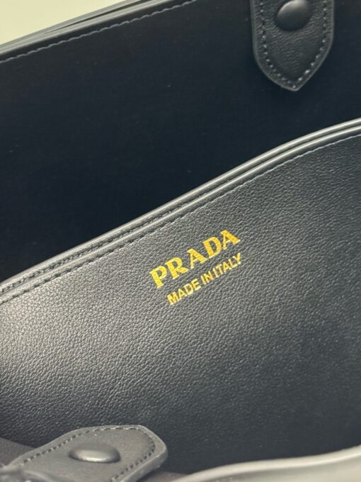 PRADA Buckle Small Leather Handbag. Authentic quality luxury bag crafted in genuine leather comes with authenticity card, dust bag and gift bag. Sophistication Meets Utility. Sleek, structured, and undeniably Prada — the Buckle Small Leather Handbag captures the brand’s signature balance of minimalist elegance and refined detail. Crafted in smooth leather with a buttery-soft nappa interior, this compact piece is a masterclass in functional luxury. A standout feature? Its interchangeable belt strap, adding a bold, modern twist to the timeless silhouette. Whether you're heading to a meeting or a soirée, this bag adapts seamlessly to your mood and moment. Finished with the embossed iconic PRADA logo, it’s a quiet statement of taste and distinction. A versatile companion for the woman who appreciates precision, polish, and just the right touch of edge.