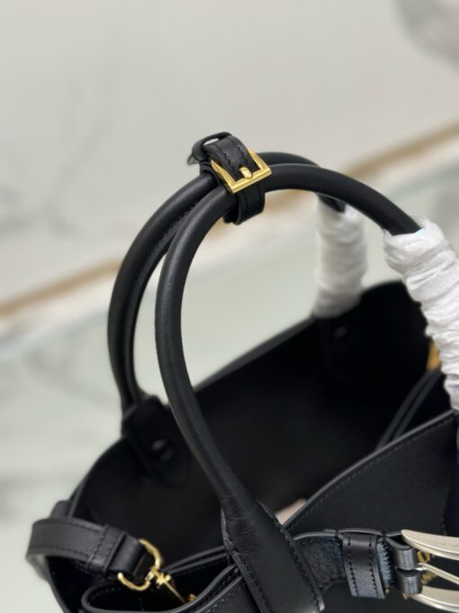 PRADA Buckle Small Leather Handbag. Authentic quality luxury bag crafted in genuine leather comes with authenticity card, dust bag and gift bag. Sophistication Meets Utility. Sleek, structured, and undeniably Prada — the Buckle Small Leather Handbag captures the brand’s signature balance of minimalist elegance and refined detail. Crafted in smooth leather with a buttery-soft nappa interior, this compact piece is a masterclass in functional luxury. A standout feature? Its interchangeable belt strap, adding a bold, modern twist to the timeless silhouette. Whether you're heading to a meeting or a soirée, this bag adapts seamlessly to your mood and moment. Finished with the embossed iconic PRADA logo, it’s a quiet statement of taste and distinction. A versatile companion for the woman who appreciates precision, polish, and just the right touch of edge.