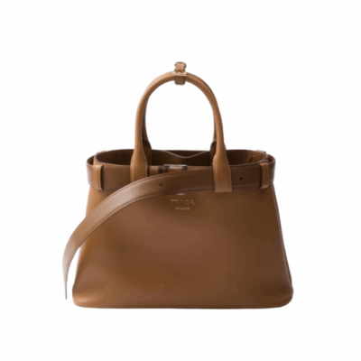 PRADA Buckle Small Leather Handbag. Authentic quality luxury bag crafted in genuine leather comes with authenticity card, dust bag and gift bag. Sophistication Meets Utility. Sleek, structured, and undeniably Prada — the Buckle Small Leather Handbag captures the brand’s signature balance of minimalist elegance and refined detail. Crafted in smooth leather with a buttery-soft nappa interior, this compact piece is a masterclass in functional luxury. A standout feature? Its interchangeable belt strap, adding a bold, modern twist to the timeless silhouette. Whether you're heading to a meeting or a soirée, this bag adapts seamlessly to your mood and moment. Finished with the embossed iconic PRADA logo, it’s a quiet statement of taste and distinction. A versatile companion for the woman who appreciates precision, polish, and just the right touch of edge.