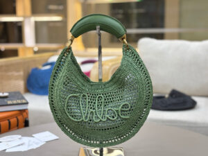 CHLOÉ Summer Banana Hobo. Authentic quality luxury bag crafted in genuine leather comes with authenticity card, dust bag and gift bag. Artisanal Spirit, Curved in Style. Say hello to sunshine in bag form. The CHLOÉ Summer Banana Hobo Bag is a joyful blend of craftsmanship and creativity, handwoven over four days by a single artisan in collaboration with Made For A Woman. This is not just a bag—it’s a story stitched in raffia and trimmed in luxurious calfskin. Its curved, banana-inspired silhouette hugs the shoulder with ease, while the sculptural handle and handwritten signature nod to Chloé’s heritage of effortless elegance. Light, natural, and undeniably chic, it's the perfect companion for sun-soaked escapes or city strolls with a coastal state of mind. A celebration of craftsmanship, femininity, and the art of slow fashion.