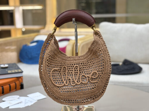 CHLOÉ Summer Banana Hobo. Authentic quality luxury bag crafted in genuine leather comes with authenticity card, dust bag and gift bag. Artisanal Spirit, Curved in Style. Say hello to sunshine in bag form. The CHLOÉ Summer Banana Hobo Bag is a joyful blend of craftsmanship and creativity, handwoven over four days by a single artisan in collaboration with Made For A Woman. This is not just a bag—it’s a story stitched in raffia and trimmed in luxurious calfskin. Its curved, banana-inspired silhouette hugs the shoulder with ease, while the sculptural handle and handwritten signature nod to Chloé’s heritage of effortless elegance. Light, natural, and undeniably chic, it's the perfect companion for sun-soaked escapes or city strolls with a coastal state of mind. A celebration of craftsmanship, femininity, and the art of slow fashion.