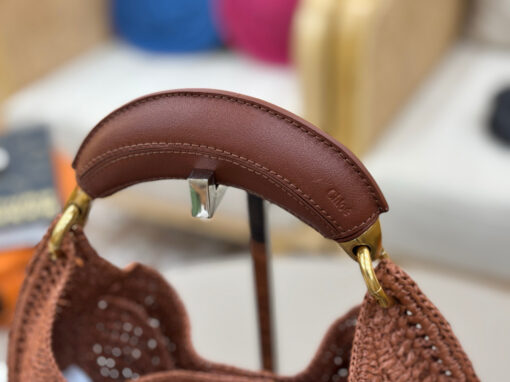 CHLOÉ Summer Banana Hobo. Authentic quality luxury bag crafted in genuine leather comes with authenticity card, dust bag and gift bag. Artisanal Spirit, Curved in Style. Say hello to sunshine in bag form. The CHLOÉ Summer Banana Hobo Bag is a joyful blend of craftsmanship and creativity, handwoven over four days by a single artisan in collaboration with Made For A Woman. This is not just a bag—it’s a story stitched in raffia and trimmed in luxurious calfskin. Its curved, banana-inspired silhouette hugs the shoulder with ease, while the sculptural handle and handwritten signature nod to Chloé’s heritage of effortless elegance. Light, natural, and undeniably chic, it's the perfect companion for sun-soaked escapes or city strolls with a coastal state of mind. A celebration of craftsmanship, femininity, and the art of slow fashion.
