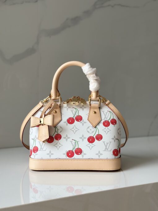 LV x TM Alma BB. Authentic quality luxury bag crafted in genuine leather comes with authenticity card, dust bag and gift bag. A Joyful Icon Reimagined. Playful, artistic, and instantly iconic—the Alma BB returns in a joyful re-edition as part of the celebrated LV x Murakami collection. This petite masterpiece blends the timeless Art Deco-inspired silhouette with Takashi Murakami’s signature whimsy, splashing the House’s Monogram canvas with bold, cherry-bright motifs. Crafted with natural leather accents and finished with polished gold-tone hardware, it features structured Toron top handles and a charming bow-shaped keybell that adds just the right amount of flirt. Compact yet attention-commanding, the Alma BB is a true collectible—full of joy, color, and unmistakable LV heritage. Carry art. Wear happiness. Make a statement.