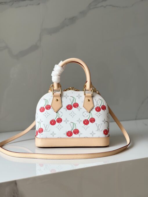 LV x TM Alma BB. Authentic quality luxury bag crafted in genuine leather comes with authenticity card, dust bag and gift bag. A Joyful Icon Reimagined. Playful, artistic, and instantly iconic—the Alma BB returns in a joyful re-edition as part of the celebrated LV x Murakami collection. This petite masterpiece blends the timeless Art Deco-inspired silhouette with Takashi Murakami’s signature whimsy, splashing the House’s Monogram canvas with bold, cherry-bright motifs. Crafted with natural leather accents and finished with polished gold-tone hardware, it features structured Toron top handles and a charming bow-shaped keybell that adds just the right amount of flirt. Compact yet attention-commanding, the Alma BB is a true collectible—full of joy, color, and unmistakable LV heritage. Carry art. Wear happiness. Make a statement.